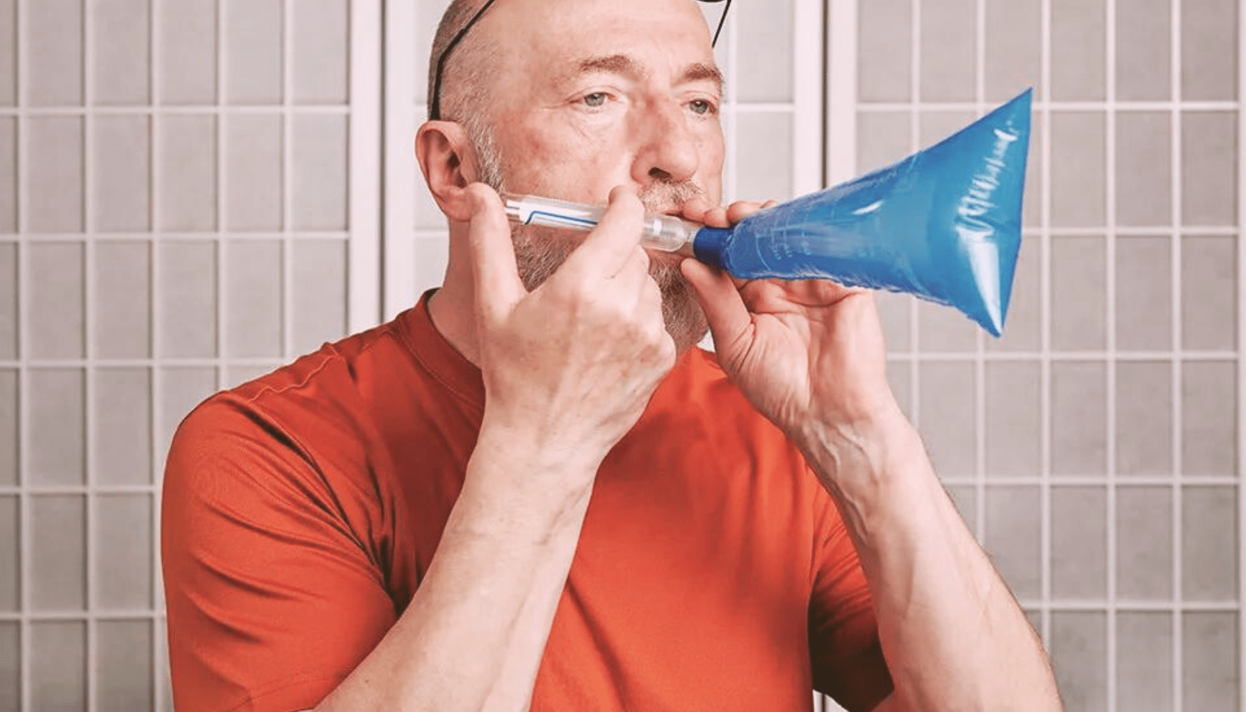 A man performing a SIBO breath test.